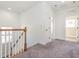 Hallway with carpet, leading to bedrooms with natural light, and neutral tones at 5347 Cypress Ln, Raleigh, NC 27609