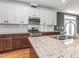 Bright kitchen with white subway tile backsplash, stainless steel appliances, granite countertops, and modern fixtures at 5347 Cypress Ln, Raleigh, NC 27609