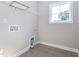 Laundry room with tile flooring, a bright window, and shelving for extra storage at 5347 Cypress Ln, Raleigh, NC 27609