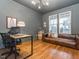 Stylized living room with hardwood floors, updated lighting, stylish décor, and a large window at 5347 Cypress Ln, Raleigh, NC 27609