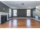 Living room with hardwood flooring, a fireplace, and plenty of natural light from the large windows at 5347 Cypress Ln, Raleigh, NC 27609