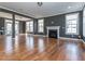 Spacious living room with hardwood flooring, fireplace, and multiple windows for natural light at 5347 Cypress Ln, Raleigh, NC 27609