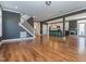 Open layout featuring hardwood floors, a staircase, and a view of the kitchen and outdoor access at 5347 Cypress Ln, Raleigh, NC 27609