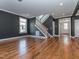 Bright living room with hardwood floors, a staircase, and neutral paint, creating a welcoming atmosphere at 5347 Cypress Ln, Raleigh, NC 27609