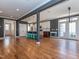 Open-concept living space featuring hardwood floors, modern fixtures, and a kitchen with an island and seating at 5347 Cypress Ln, Raleigh, NC 27609
