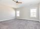 Spacious main bedroom with plush carpet flooring and two windows offering natural light at 5347 Cypress Ln, Raleigh, NC 27609