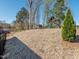 Wooden playset with slide surrounded by mature trees providing a shaded area for children at 5347 Cypress Ln, Raleigh, NC 27609