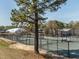 Multiple outdoor tennis courts surrounded by a fence and trees offer recreational opportunities at 5347 Cypress Ln, Raleigh, NC 27609