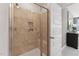 Shower enclosure featuring tan tile with a built-in niche and a bench at 600 Hedrick Ridge Road # 112, Cary, NC 27519