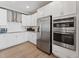 Modern kitchen features stainless steel appliances, white cabinets, and granite countertops for a sleek and clean look at 600 Hedrick Ridge Road # 112, Cary, NC 27519