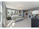 Comfortable main bedroom featuring neutral walls, a comfortable bed, and a modern light fixture at 600 Hedrick Ridge Road # 112, Cary, NC 27519