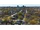 Expansive aerial view of a neighborhood showcasing lush greenery and city skyline in the distance at 602 Gray Ave, Durham, NC 27701