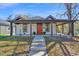 Charming renovated bungalow with a bright red door, covered porch and manicured landscaping at 602 Gray Ave, Durham, NC 27701