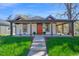 Charming single-story home with a covered porch, an orange front door, and well-manicured lawn at 602 Gray Ave, Durham, NC 27701