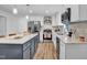 Modern kitchen with white cabinets, stainless steel appliances, and a center island, perfect for cooking at 602 Gray Ave, Durham, NC 27701