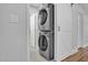 Efficient laundry area featuring a stacked washer and dryer set, complete with sliding barn door at 602 Gray Ave, Durham, NC 27701