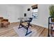 Minimalist office space with a glass desk, laminate flooring, and ample natural light for a productive workspace at 602 Gray Ave, Durham, NC 27701