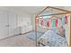 Well-lit bedroom featuring a unique wooden bed frame, bright window, and ample closet space at 6529 Winter Spring Dr, Wake Forest, NC 27587