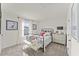 Bright bedroom featuring a metal frame bed, plush rug, and natural light from the window at 6529 Winter Spring Dr, Wake Forest, NC 27587