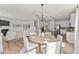 Bright and open dining area with modern furniture, seamlessly connected to the kitchen and living room at 6529 Winter Spring Dr, Wake Forest, NC 27587