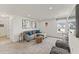 Cozy living room with a comfortable gray sectional sofa, stylish décor and abundant natural light at 6529 Winter Spring Dr, Wake Forest, NC 27587