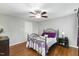 Bedroom with ceiling fan, hardwood floors, and gray walls at 6750 Olde Province Ct, Raleigh, NC 27609