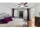Comfortable bedroom featuring a ceiling fan and hardwood floors at 6750 Olde Province Ct, Raleigh, NC 27609