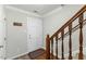 Hallway with hardwood floors and view of staircase and front door at 6750 Olde Province Ct, Raleigh, NC 27609
