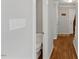 Hallway with hardwood floors and view of a powder room at 6750 Olde Province Ct, Raleigh, NC 27609