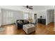 Bright living room with fireplace, hardwood flooring, and stylish ottoman; ideal for entertaining guests and everyday comfort at 6750 Olde Province Ct, Raleigh, NC 27609