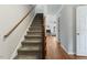 Carpeted staircase with wooden banister leads to the upper level at 6750 Olde Province Ct, Raleigh, NC 27609