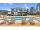 A large backyard features an in-ground pool, a grill, a patio, and outdoor seating at 73 Clyde Pearce Rd, Zebulon, NC 27597
