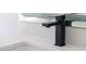 Close-up of a modern black faucet on white bathroom sink at 73 Clyde Pearce Rd, Zebulon, NC 27597
