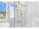 Elegant bathroom with marble tile, glass-enclosed shower, and sleek vanity at 73 Clyde Pearce Rd, Zebulon, NC 27597