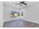 Well-lit bedroom with hardwood floors and large windows overlooking the backyard at 73 Clyde Pearce Rd, Zebulon, NC 27597