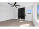 Bedroom with ceiling fan, hard wood flooring, and large window view at 73 Clyde Pearce Rd, Zebulon, NC 27597
