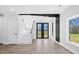Open-concept entryway features a glass staircase and double doors leading to the outdoor view at 73 Clyde Pearce Rd, Zebulon, NC 27597
