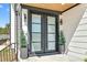 Elegant double front doors framed by black trim and complemented by small potted trees at 73 Clyde Pearce Rd, Zebulon, NC 27597