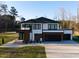 Modern two-story home featuring an attached garage, black framed windows, and manicured front yard at 73 Clyde Pearce Rd, Zebulon, NC 27597