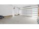 Spacious garage featuring a white garage door and separate access door with natural light at 73 Clyde Pearce Rd, Zebulon, NC 27597