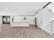 Well-lit kitchen with hardwood floors, a large island, and white cabinets offering ample storage at 73 Clyde Pearce Rd, Zebulon, NC 27597