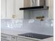 Modern kitchen with white cabinets, stainless steel appliances, and a sleek cooktop at 73 Clyde Pearce Rd, Zebulon, NC 27597