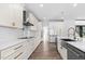 Well-appointed kitchen with white cabinets, quartz countertops, and modern appliances at 73 Clyde Pearce Rd, Zebulon, NC 27597