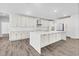 Spacious kitchen with white cabinets, quartz countertops, and a large center island at 73 Clyde Pearce Rd, Zebulon, NC 27597