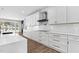 Elegant kitchen features white cabinets, quartz countertops, and stainless steel appliances with views of the pool at 73 Clyde Pearce Rd, Zebulon, NC 27597