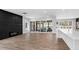 Spacious living room with a modern fireplace, leading to a screened porch and pool area at 73 Clyde Pearce Rd, Zebulon, NC 27597
