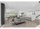 Bright and modern living room with hardwood floors, comfortable seating, and an open kitchen at 73 Clyde Pearce Rd, Zebulon, NC 27597