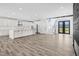 Open-concept living space featuring hardwood floors, a modern kitchen, and an entryway at 73 Clyde Pearce Rd, Zebulon, NC 27597