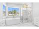 Luxurious bathroom with soaking tub, walk-in shower, and marble flooring in a new house at 73 Clyde Pearce Rd, Zebulon, NC 27597