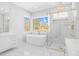 Luxurious bathroom with soaking tub, walk-in shower, and marble flooring in a new house at 73 Clyde Pearce Rd, Zebulon, NC 27597